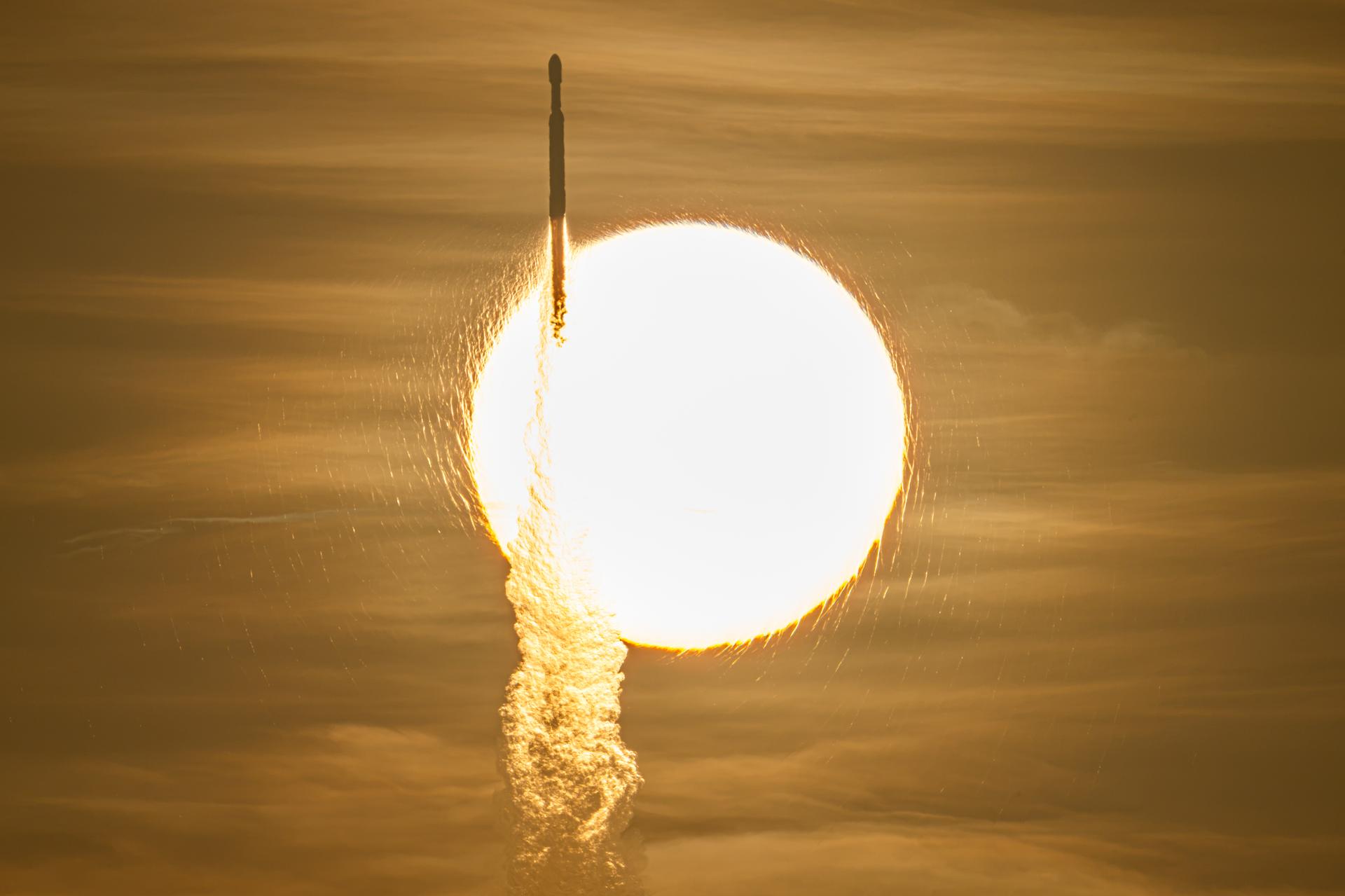 A SpaceX Falcon Heavy carrying the Roman Space Telescope rises across the face of the Sun at launch, 30 August 2026